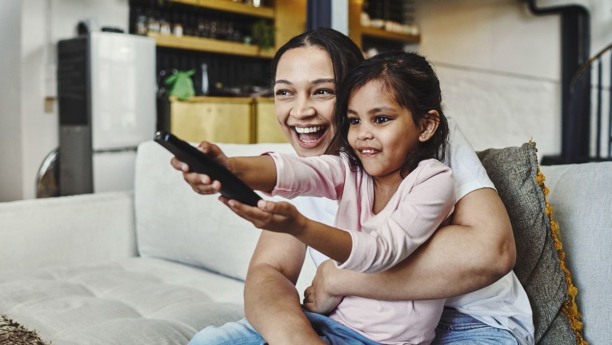 Television solution case study - mom and daughter turning on TV