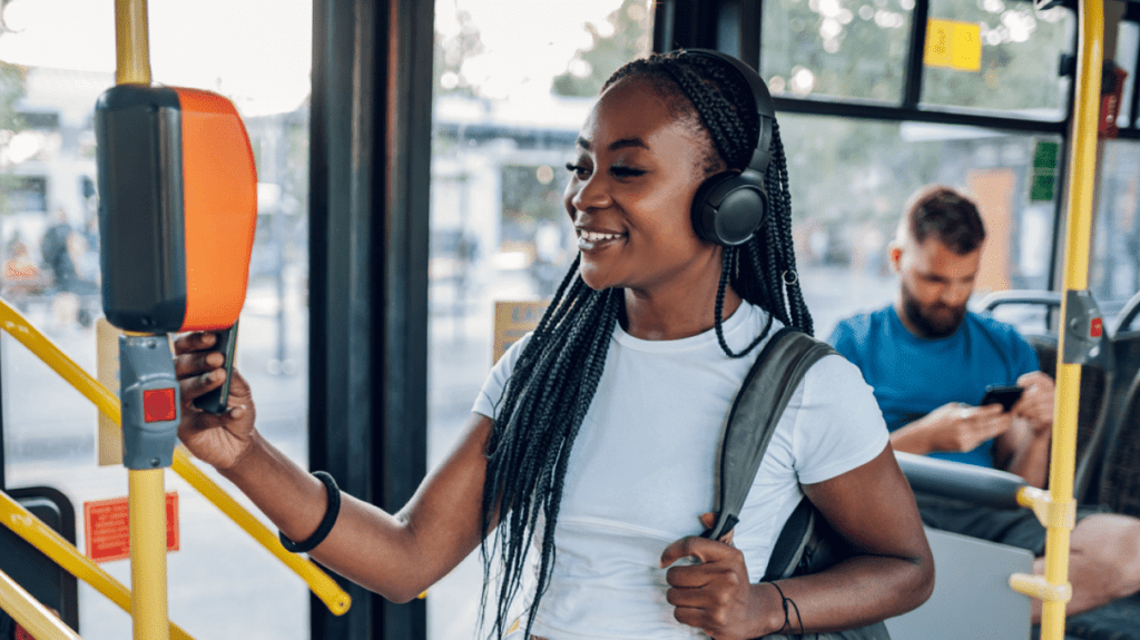 Public transportation - woman swiping phone to ride