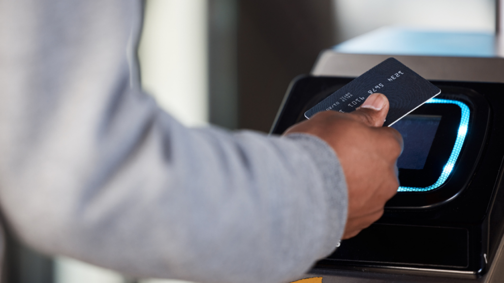 Public transportation - man swiping bank card to ride