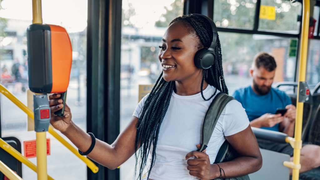 Public transportation - woman swiping phone to ride